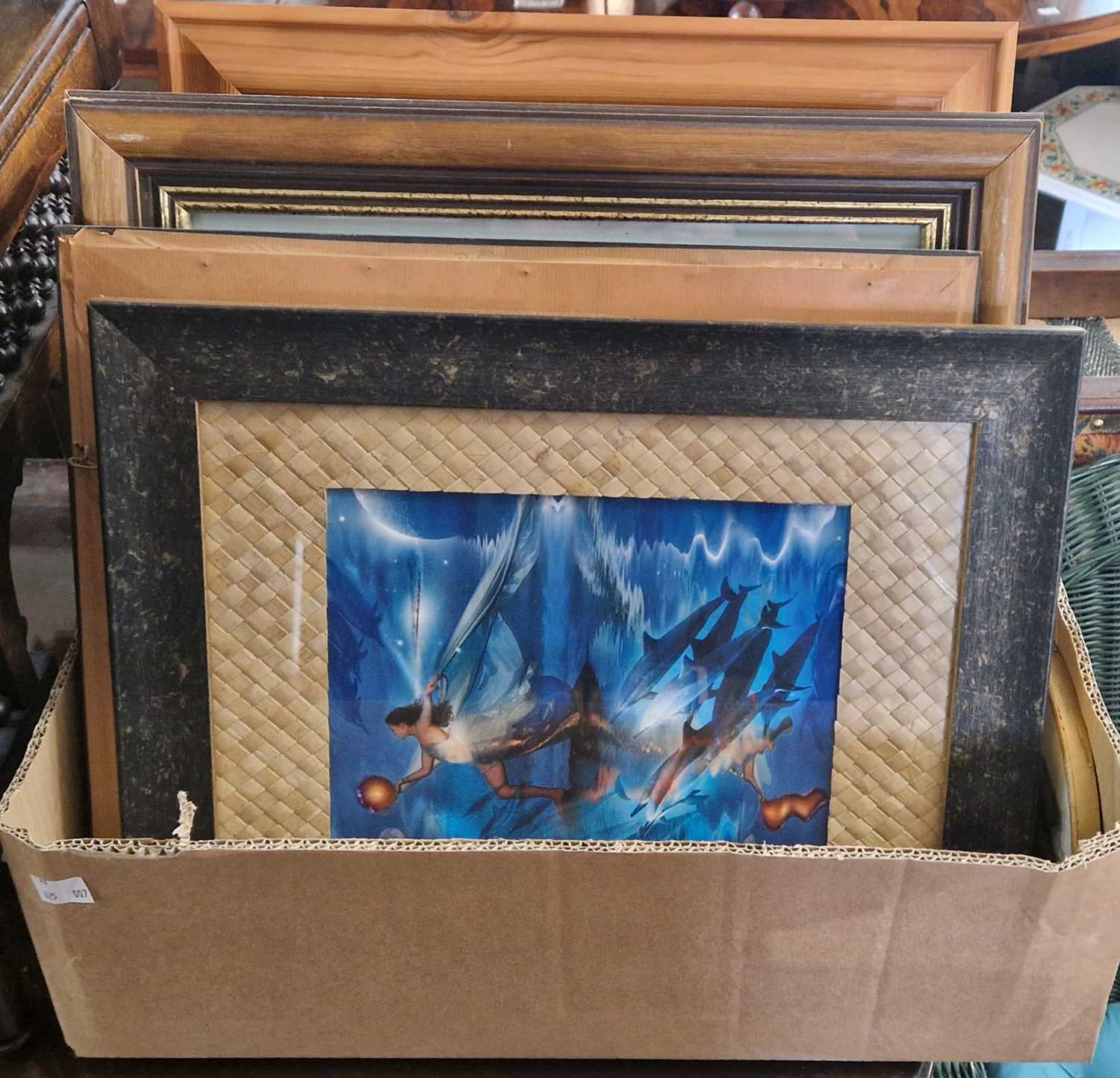 A box of assorted decorative pictures and prints to include a faux fossil panel.