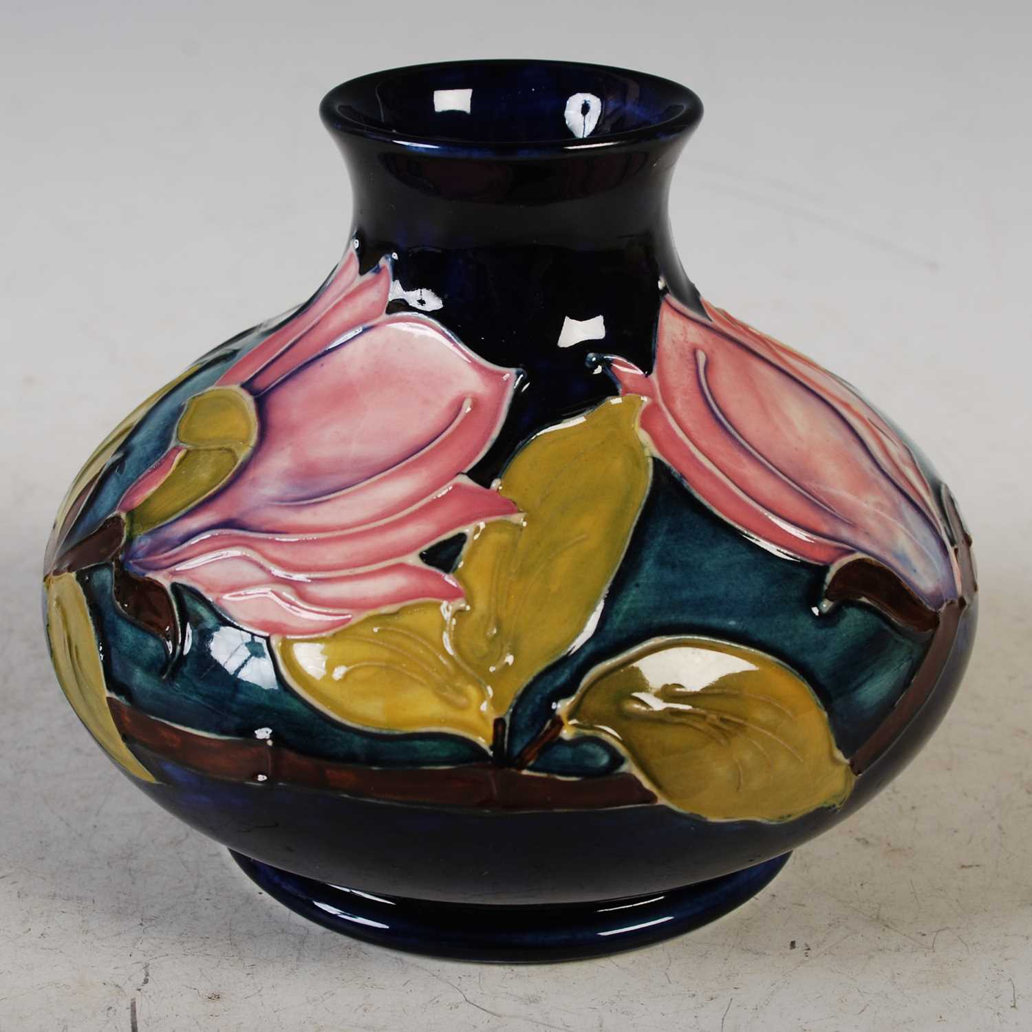 A Moorcroft pottery vase decorated with flowers and foliage on a blue ground, impressed marks, 10. - Image 2 of 3