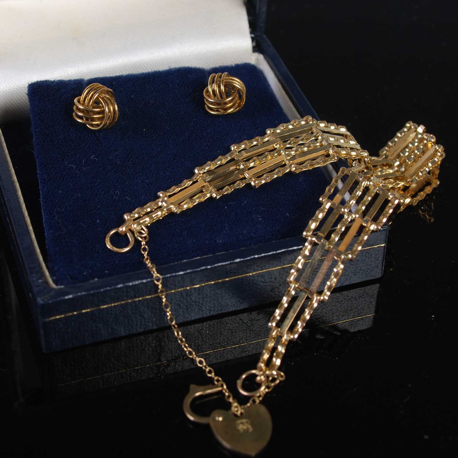 A 9ct gold gate link bracelet with heart shaped lock, together with a pair of 9ct gold earrings, one