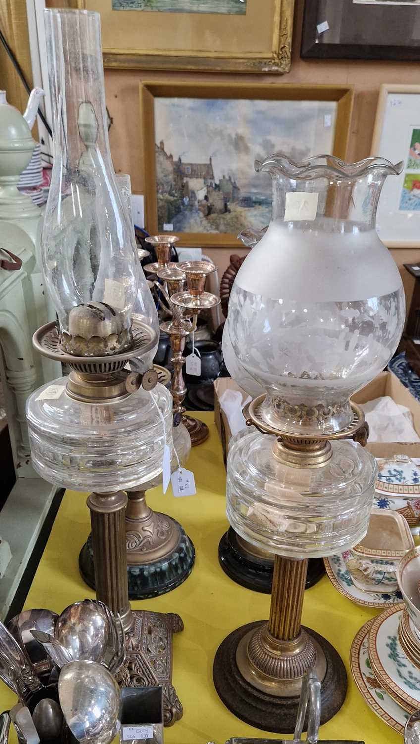 Two late 19th / early 20th century brass and glass paraffin lamps.