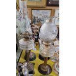 Two late 19th / early 20th century brass and glass paraffin lamps.