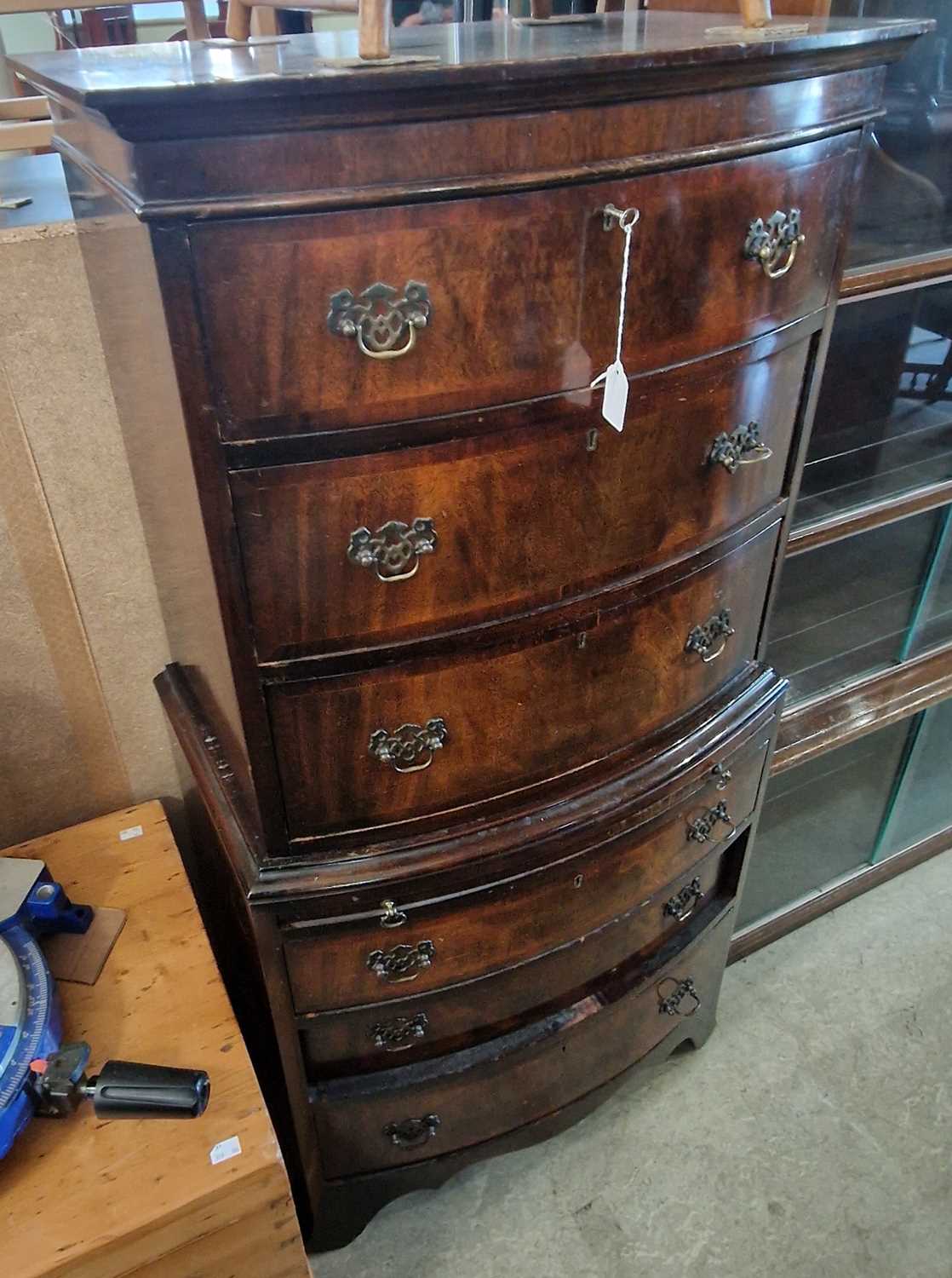A reproduction mahogany bowfront chest on chest, the upper section fitted with three drawers on a