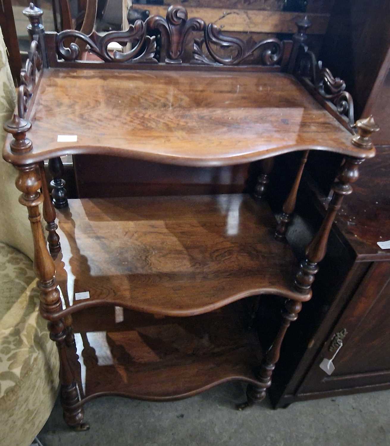 A 19th century rosewood three tier serpentine whatnot, 56cm wide x 90cm high.