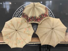 Three assorted vintage parasols / umbrellas, two with floral details and one with a border of