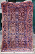 A Persian rug, mid 20th century, the rectangular blue ground decorated with six rectangular shaped