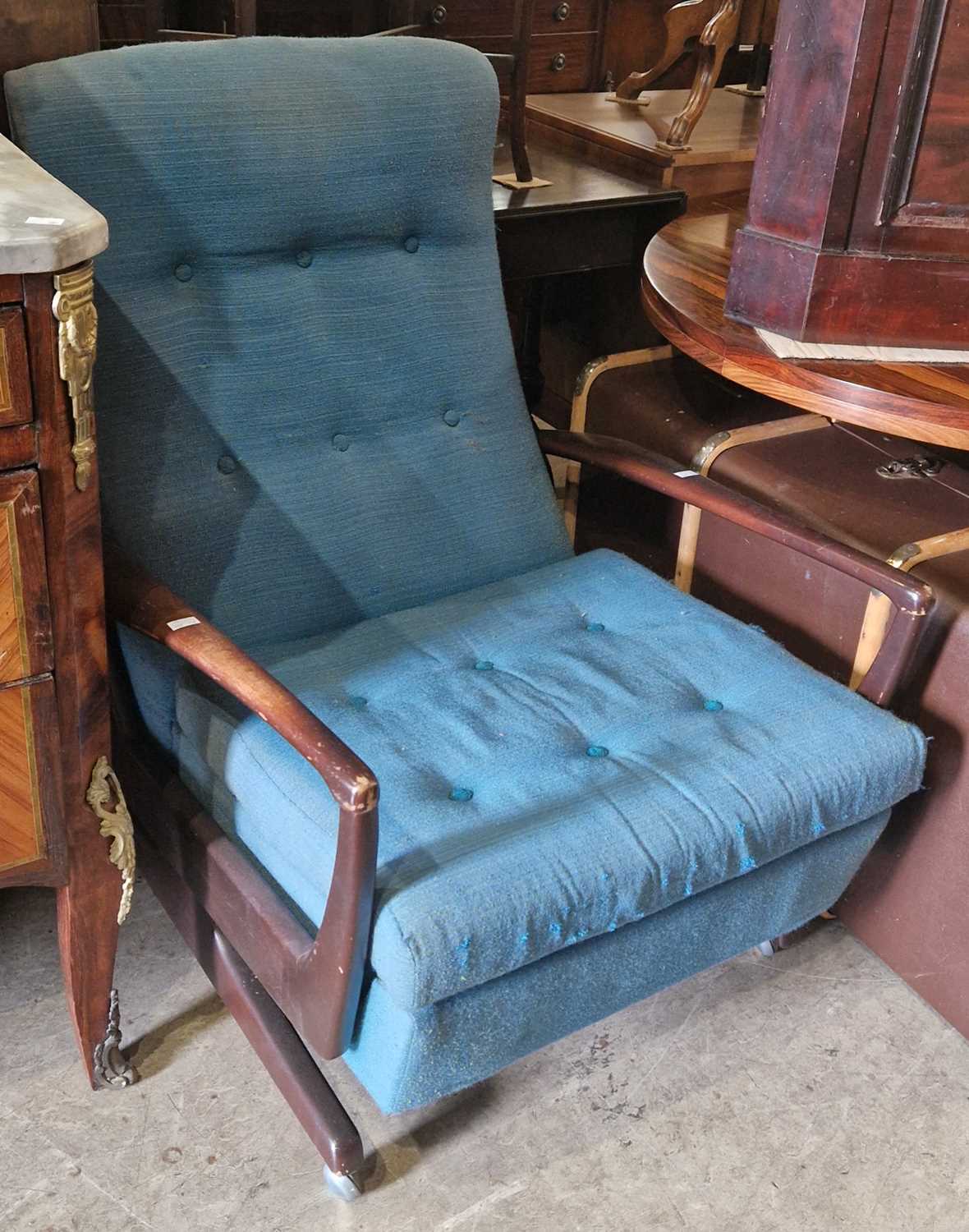 A mid-century stained wood armchair with blue upholstered button down back and loose cushion, on