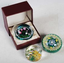 Three assorted millefiori glass paperweights to include a green ground weight by Jack Allen,