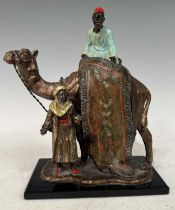 A cold painted spelter figure group of two Arabs and a camel, the mounted figure holding a rug, 18cm