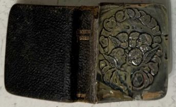 A Birmingham silver mounted book of common prayer, the silver cover embossed with cherubs