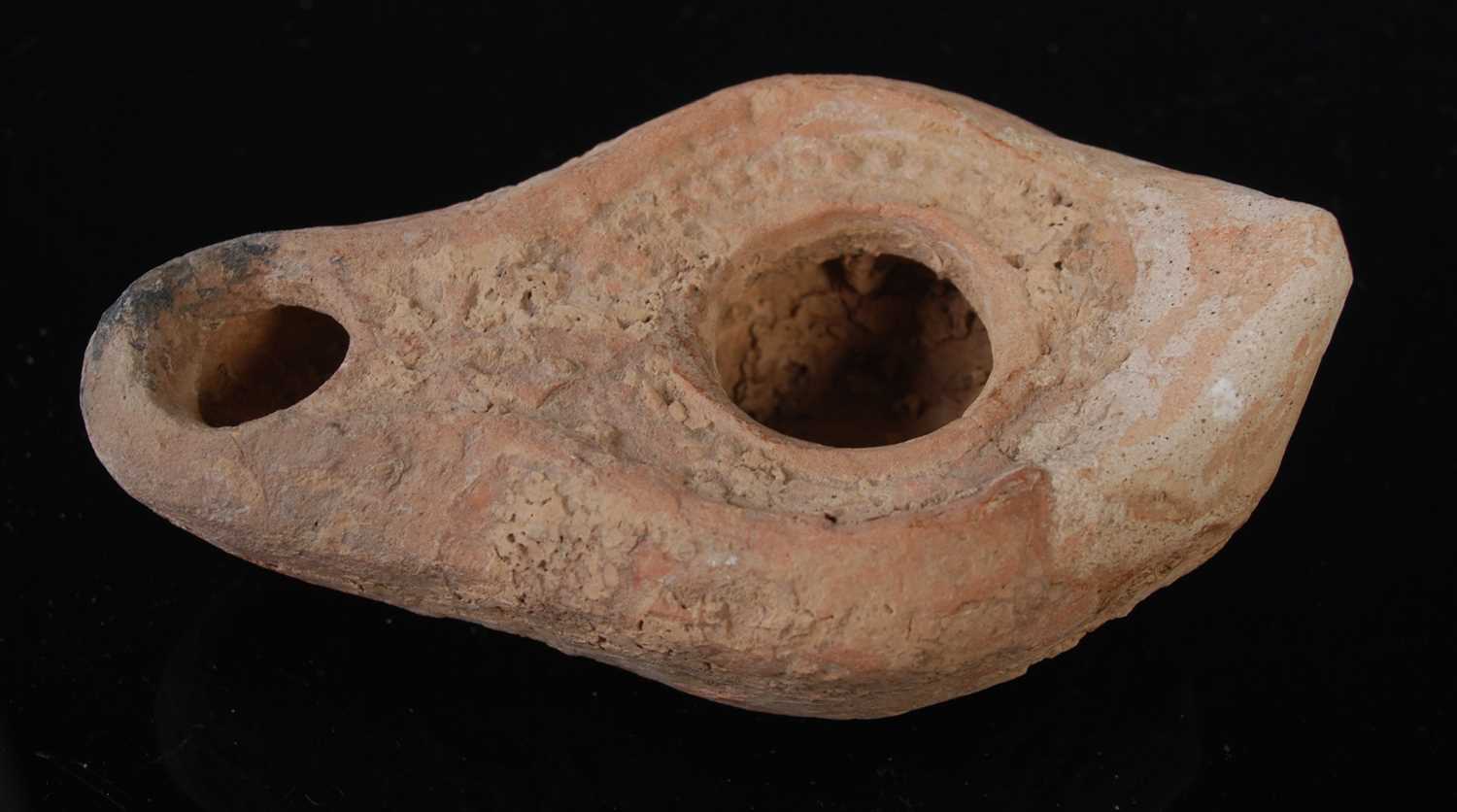 An antique pottery oil lamp, possibly Roman, 9cm long. - Image 2 of 2