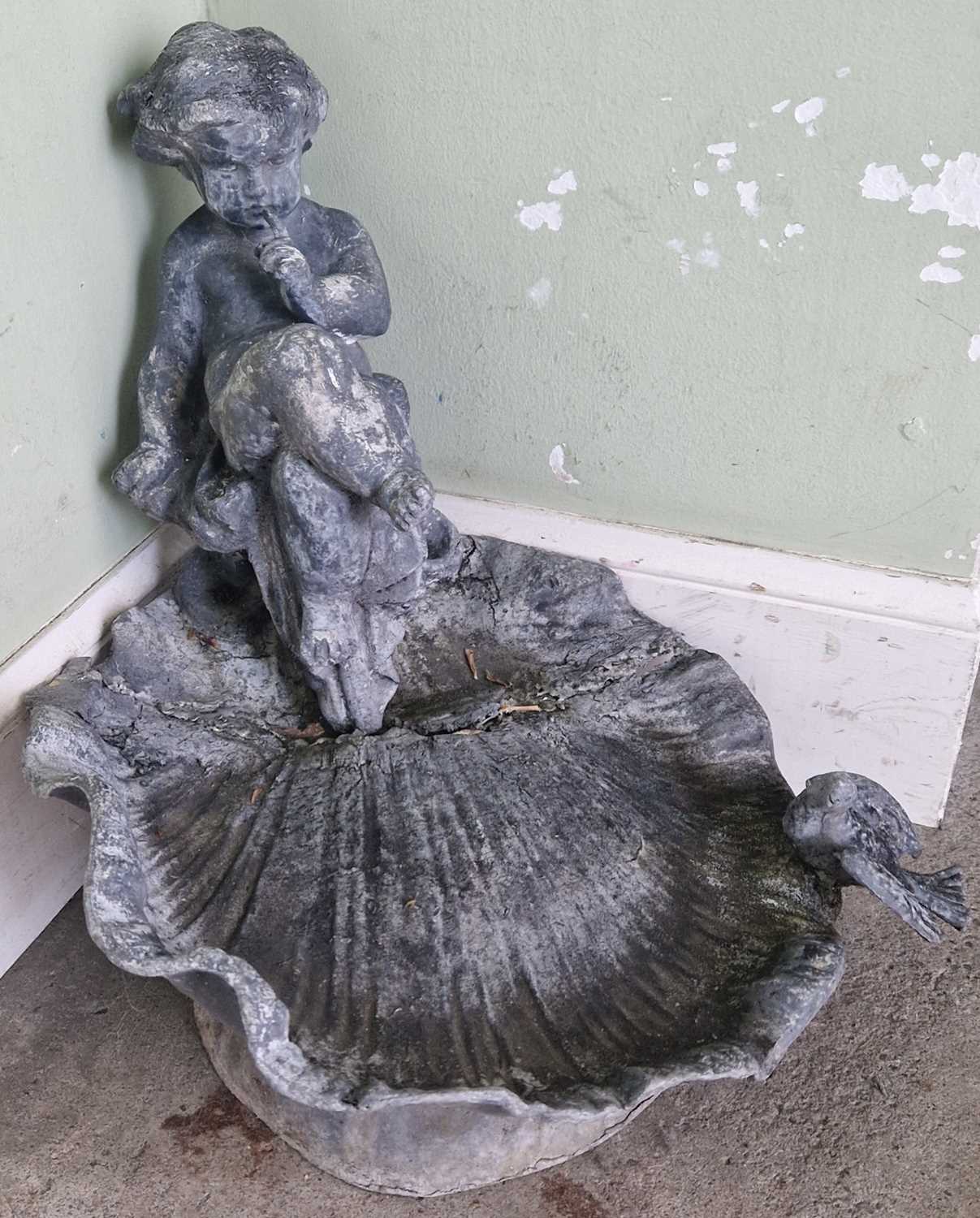 Two antique lead bird baths, each set with a cherub and bird over a shell-shaped bowl, approximately