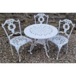 A white-painted cast metal garden table and three chairs, the table 81cm diameter.