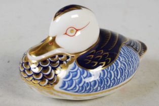 A Royal Crown Derby model of a duck with gold-coloured button, 11.5cm long.