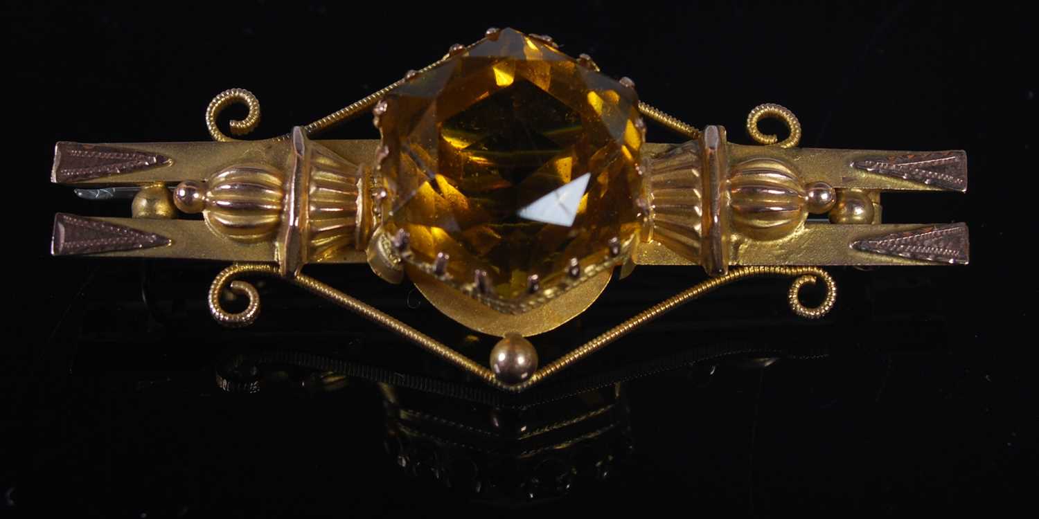 A yellow metal and citrine set bar brooch, stamped '9CT', 52.5 mm wide, gross weight 6 grams.