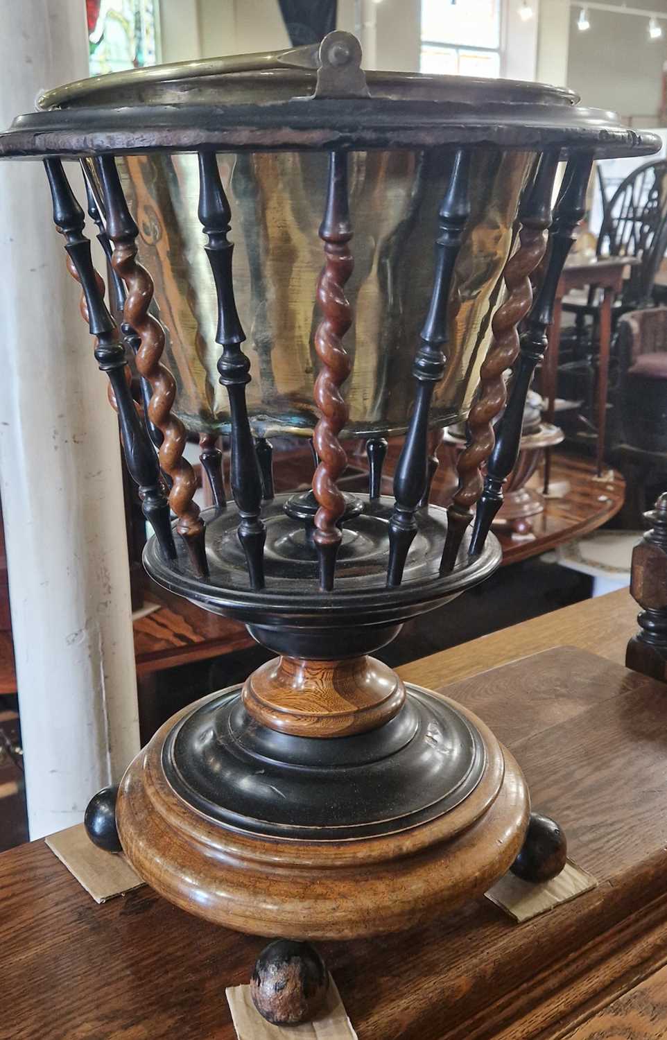 A Dutch walnut and ebonised spindle bucket with detachable brass liner raised on ball-shaped feet,