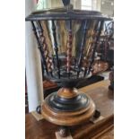 A Dutch walnut and ebonised spindle bucket with detachable brass liner raised on ball-shaped feet,