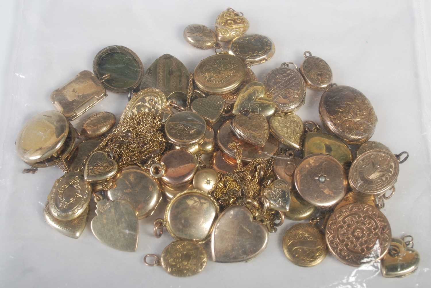 A large collection of assorted yellow metal and rolled gold heart-shaped and oval-shaped lockets,