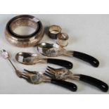 A collection of Eastern white metal wares to include a circular dish, two napkin rings, teaspoon and