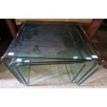 A nest of three glass rectangular occasional tables with slightly green-tint, the largest 55cm