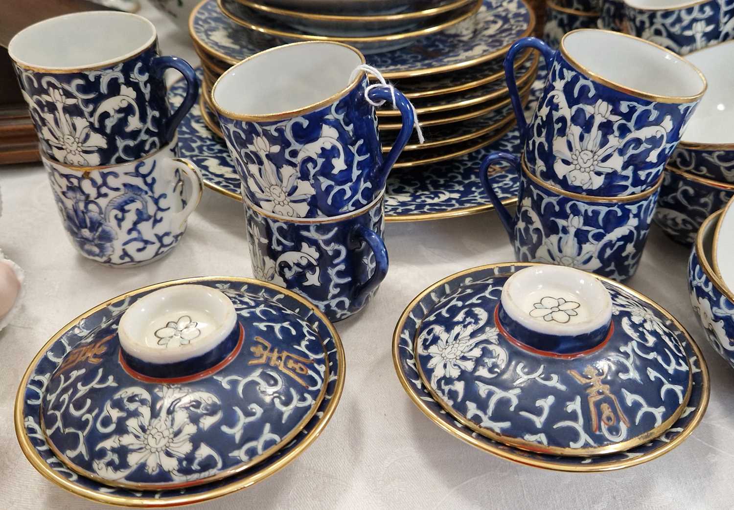 A Chinese porcelain blue and white part tea set with gilded borders, the teapot contained within a - Image 2 of 4