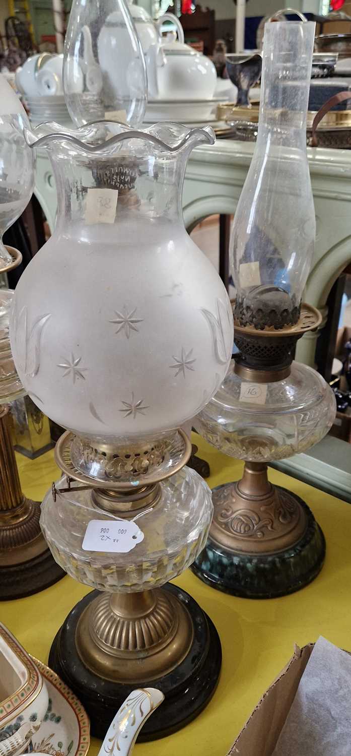 Two late 19th / early 20th century brass and glass paraffin lamps.