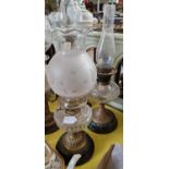 Two late 19th / early 20th century brass and glass paraffin lamps.