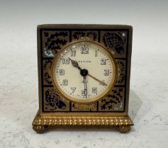 A vintage Zenith Swiss-Made yellow and white metal champleve enamel decorated bedside clock, the