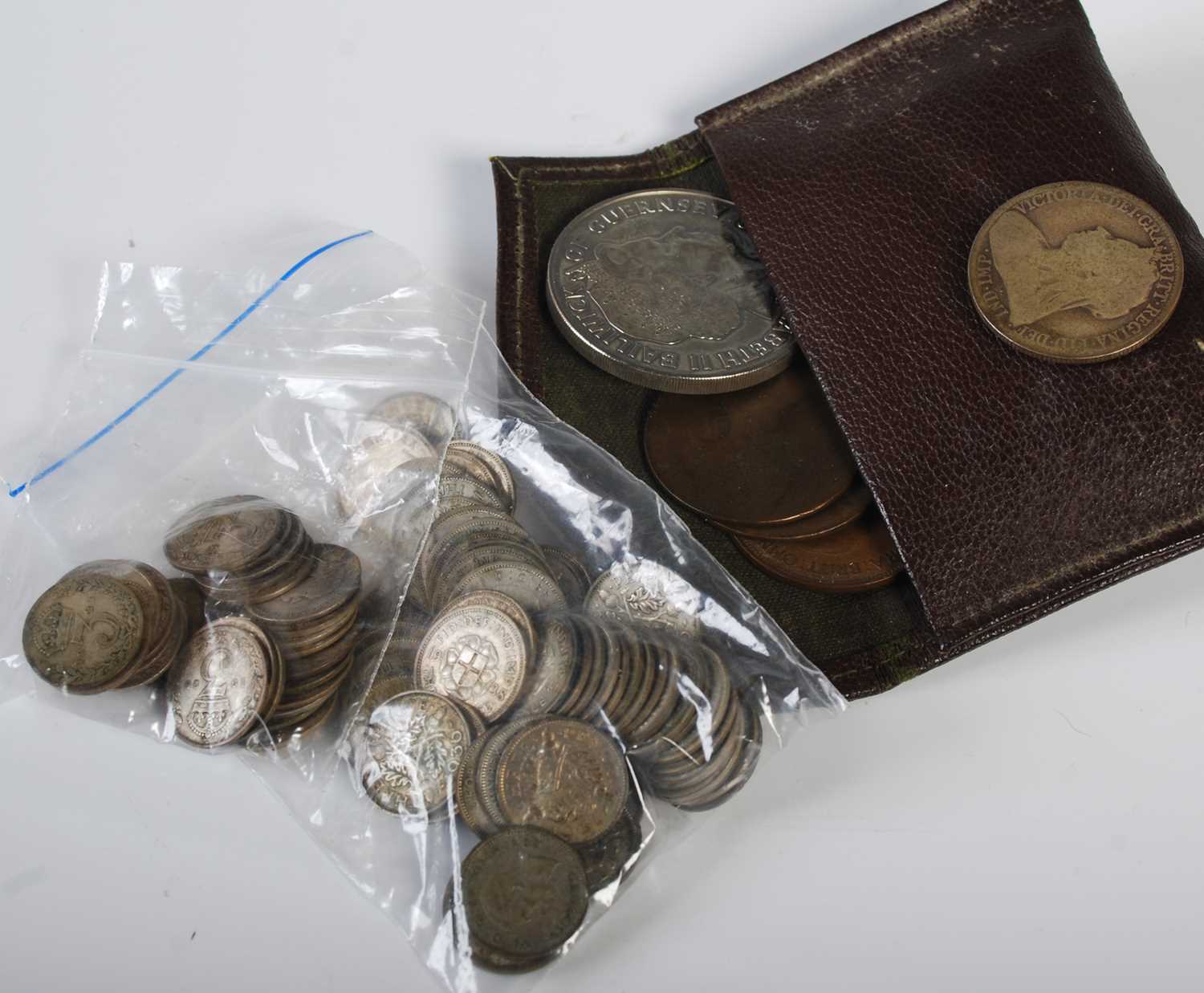 A brown leather purse containing assorted 19th century and later coinage, two bags of early 20th