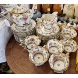 An antique porcelain hand-painted part tea set, with floral details and richly gilded borders, the