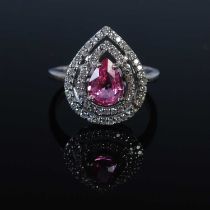 An 18ct gold Padparadscha colour sapphire and diamond ring by Rocks & Co, set with a coloured pear-