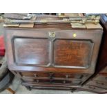 An early 20th century stained oak fall front bureau, a reproduction mahogany three tiered whatnot