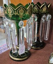 A matched pair of 19th century green glass table lustres, with gilded detail and clear glass