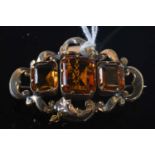 A late 19th century yellow metal three stone citrine coloured brooch, gross weight 10 grams.