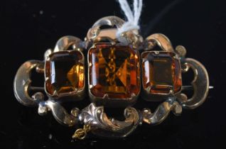 A late 19th century yellow metal three stone citrine coloured brooch, gross weight 10 grams.