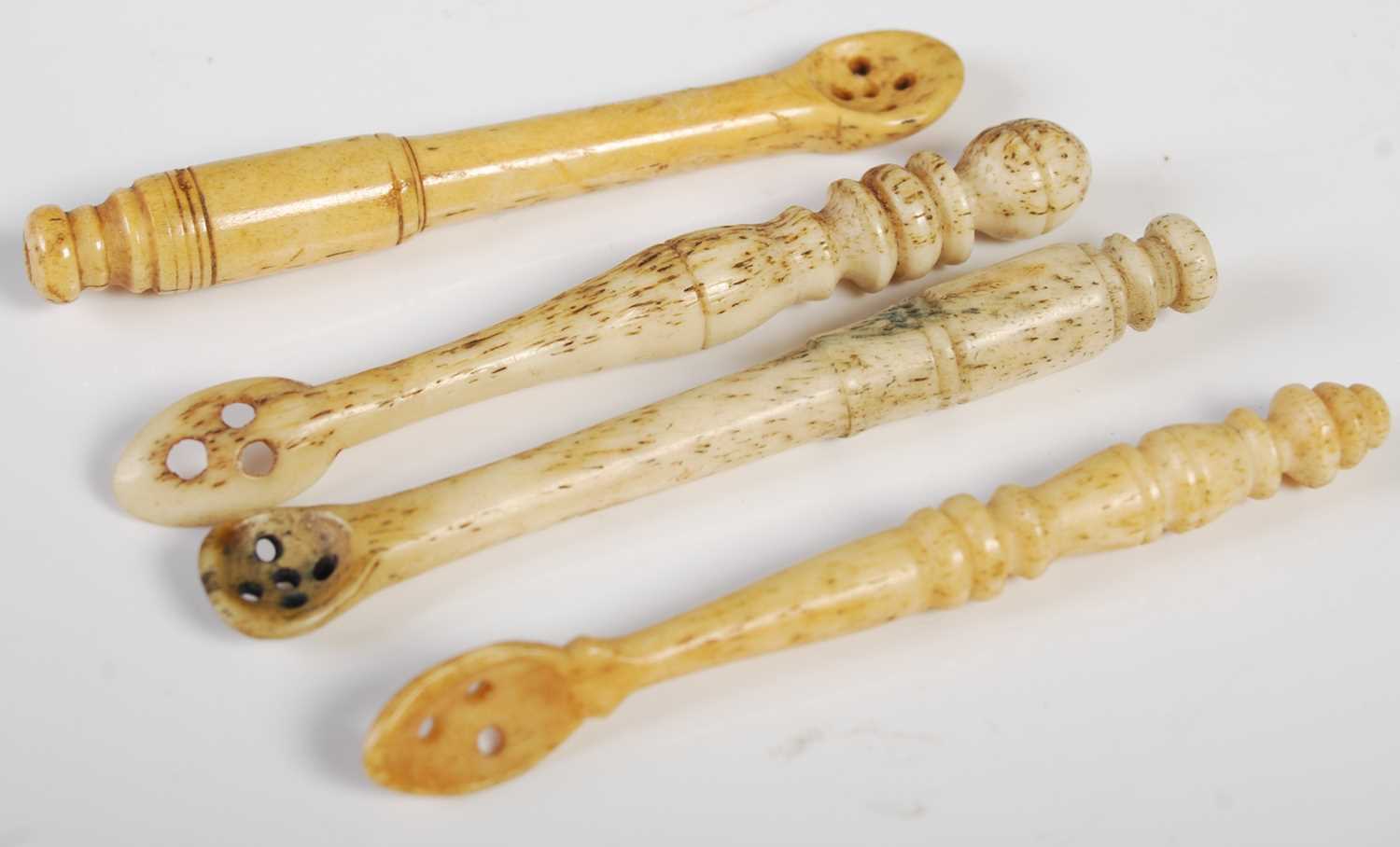 Four assorted 18th/ 19th century carved bone snuff spoons.