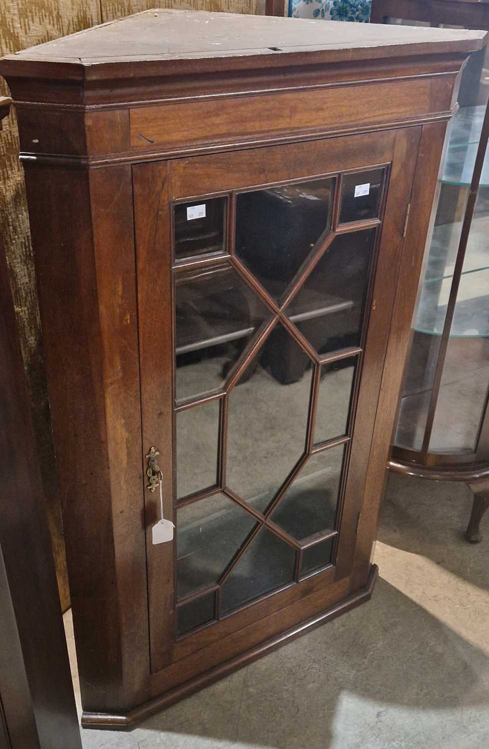 A Georgian mahogany hanging corner cupboard with astragal glazed door, opening to two shelves, 110cm