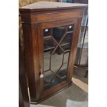 A Georgian mahogany hanging corner cupboard with astragal glazed door, opening to two shelves, 110cm