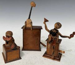A group of three assorted Japanese wooden Kobi mechanical toys, the largest 16.5cm high.