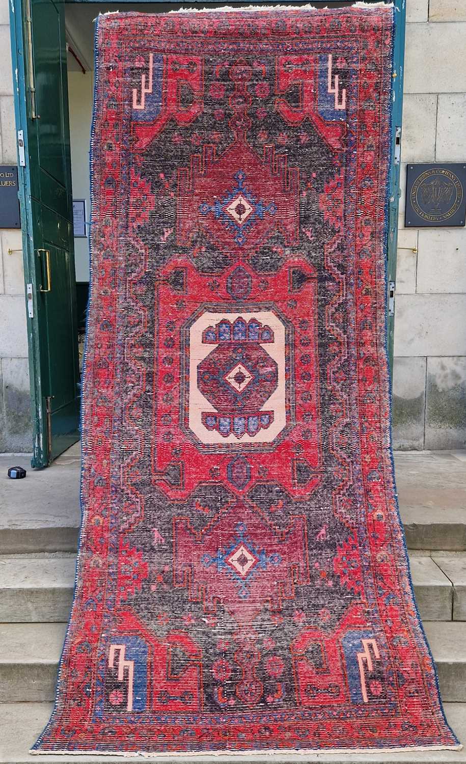 A Persian long rug, 20th century, the charcoal coloured ground centred with an ivory medallion and - Bild 2 aus 5