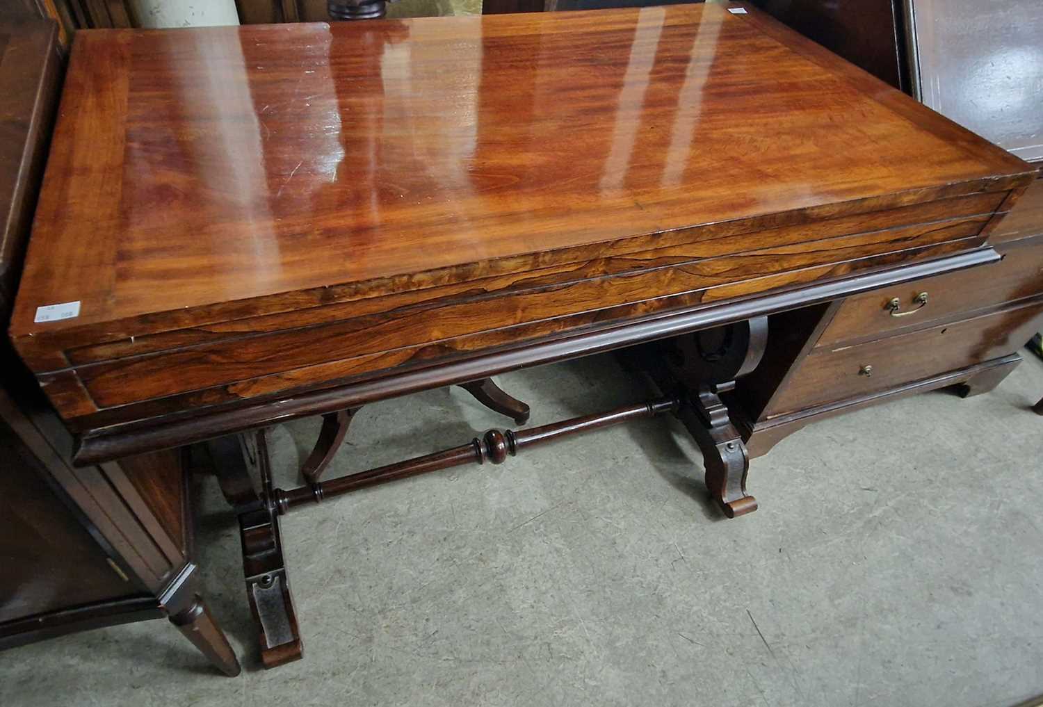 A 19th century mahogany and rosewood bagatelle table, the hinged rectangular top opening to a