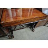 A 19th century mahogany and rosewood bagatelle table, the hinged rectangular top opening to a