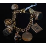 A 9ct gold charm bracelet suspending seven assorted charms, with heart shaped lock, gross weight