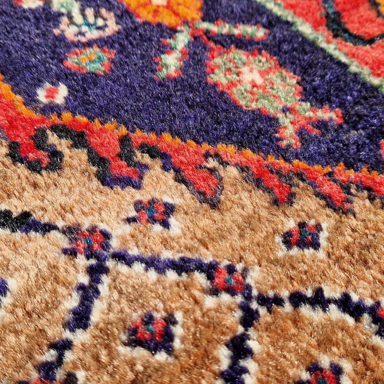 A Persian rug, 20th century, the rectangular cafe au lait coloured ground centred with a blue floral - Bild 4 aus 4