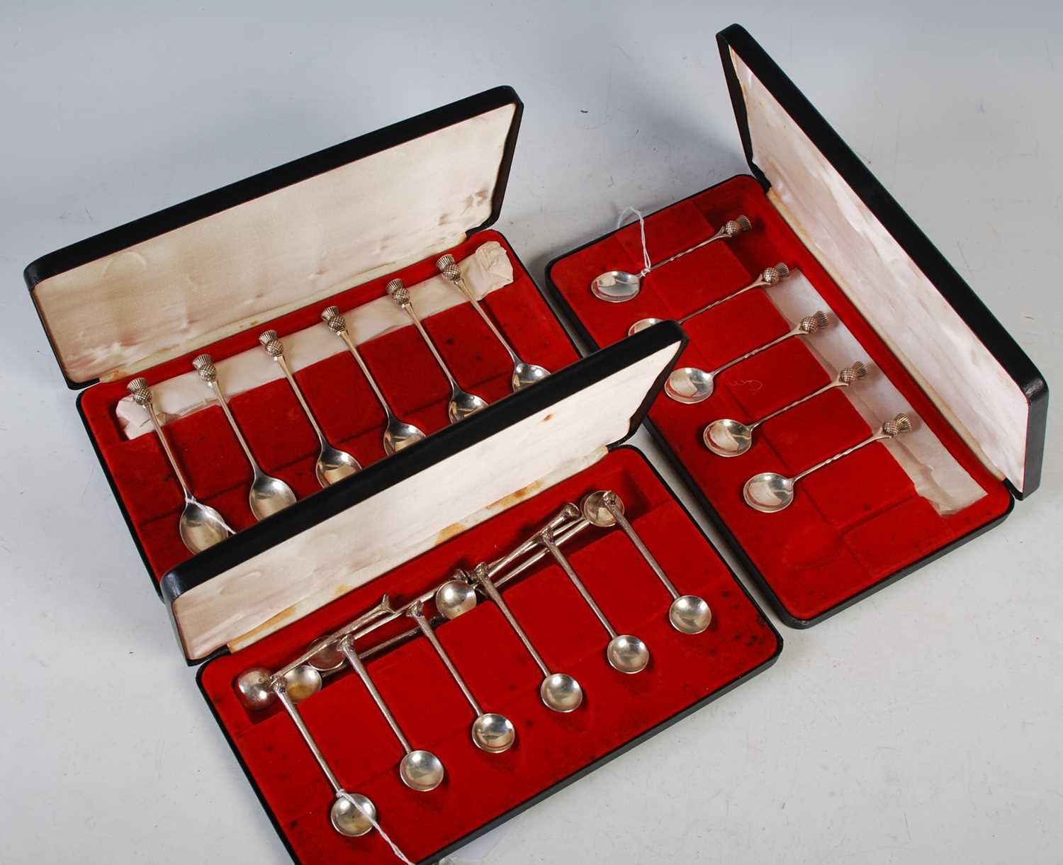 A cased set of six 20th century silver thistle topped teaspoons, Birmingham, 1975, together with a