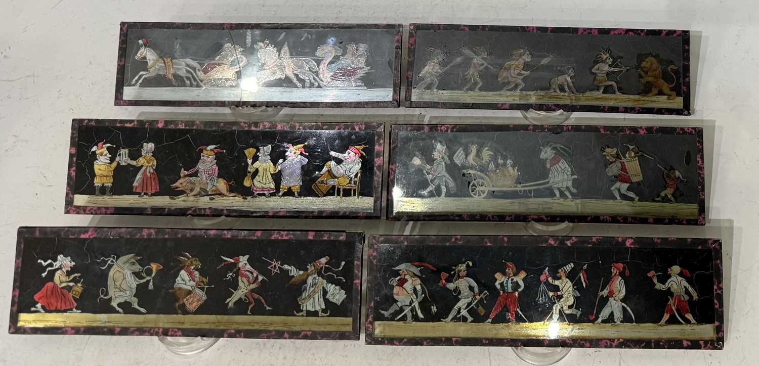 A collection of six glass Magic Lantern slides depicting whimsical scenes, together with two hand