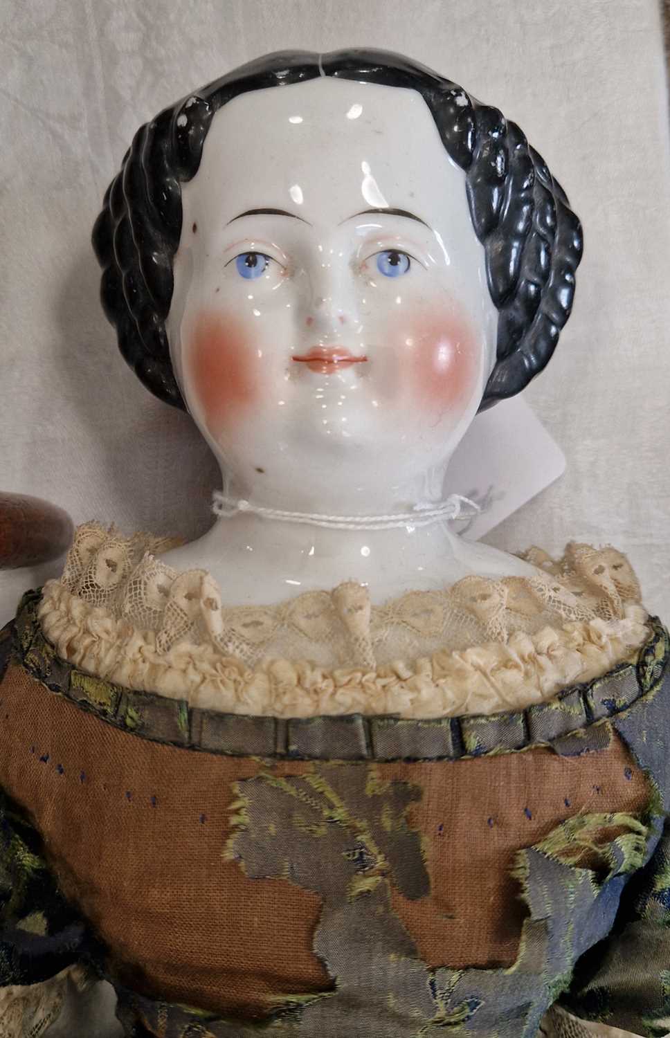 A large antique porcelain headed doll in period dress, 55cm high. - Image 2 of 2