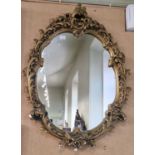 A composite gilt framed Rococo style wall mirror, 66cm x 49cm.