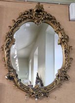 A composite gilt framed Rococo style wall mirror, 66cm x 49cm.