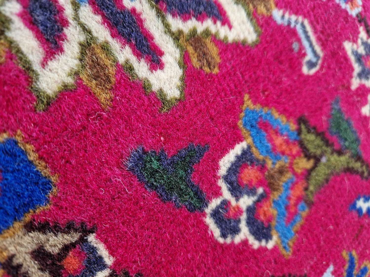 A Persian Mashad carpet, 20th century, the rectangular magenta ground centred with a blue lozenge - Image 5 of 5