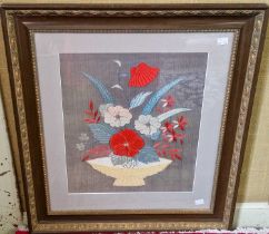 Early 20th century silk work picture, depicting a bowl issuing flowers and foliage worked in red,